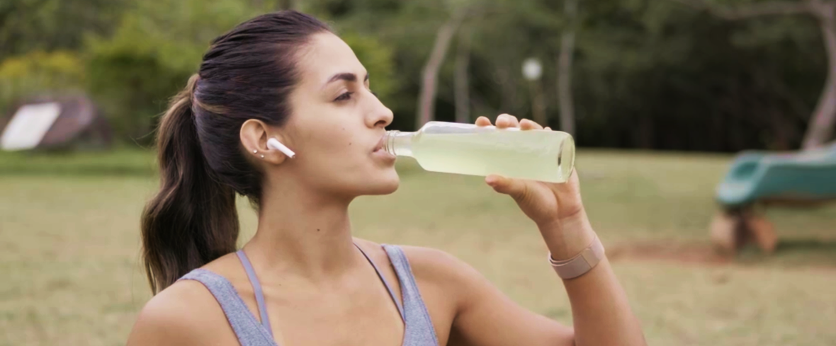 woman drinking juice in park