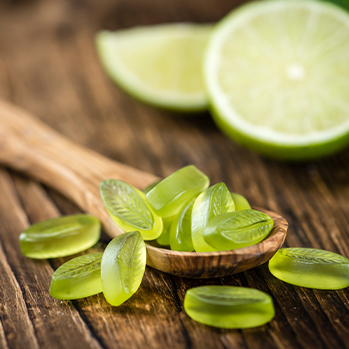 green gummy vitamins on a spoon