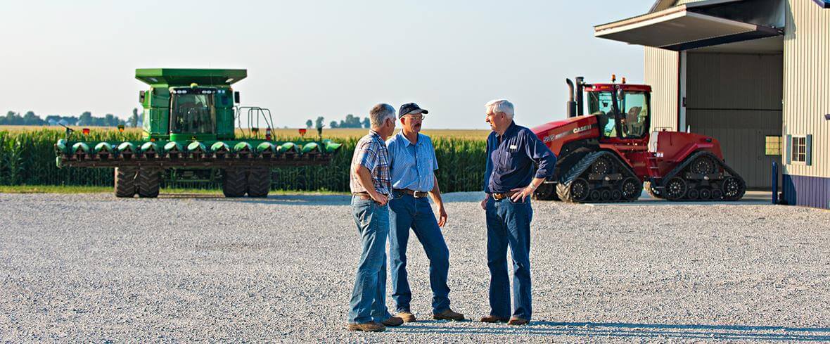 adm com hero men talking in front of tractors 20110721 blueston 149 2021 12 v1 hires