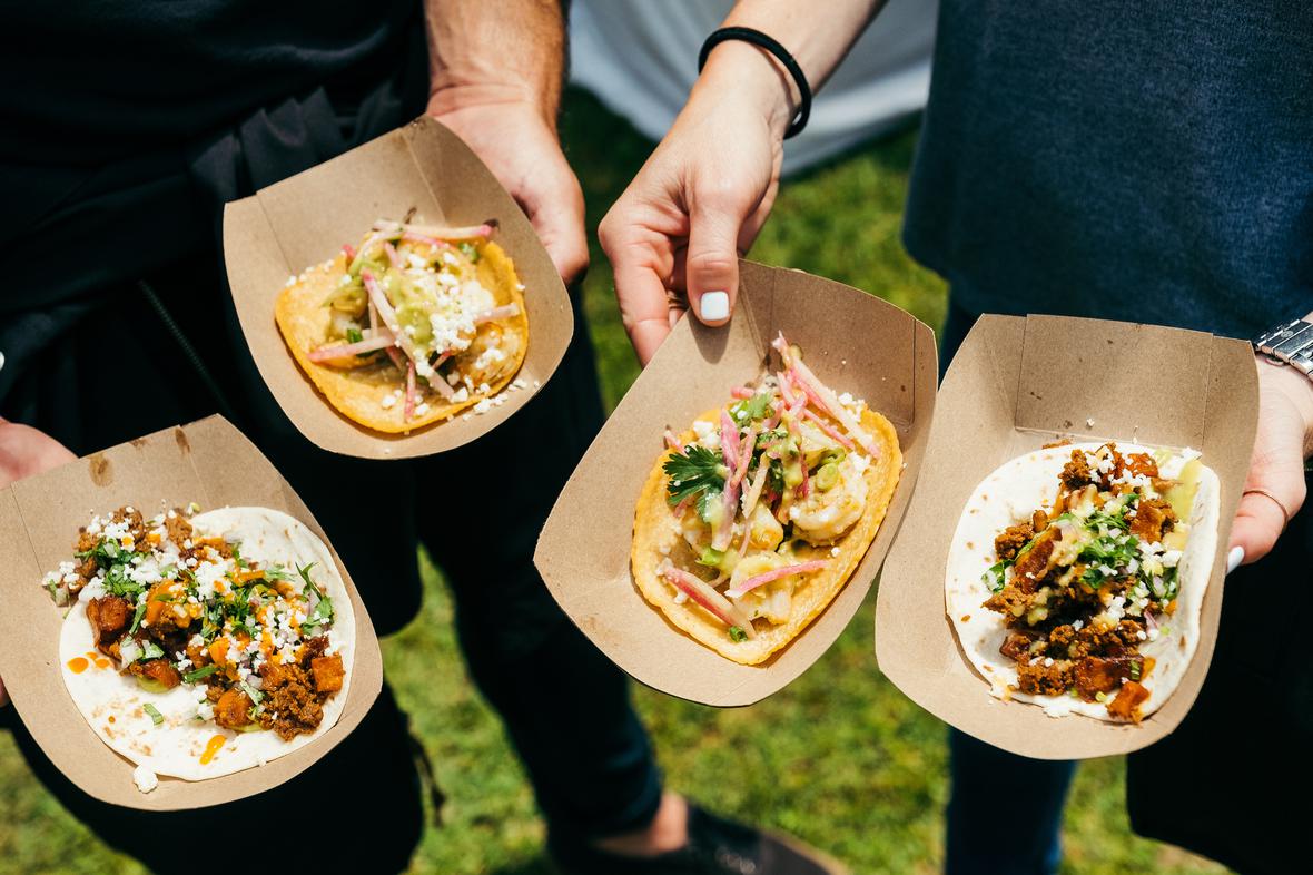 A couple enjoying colorful and healthy looking meat tacos