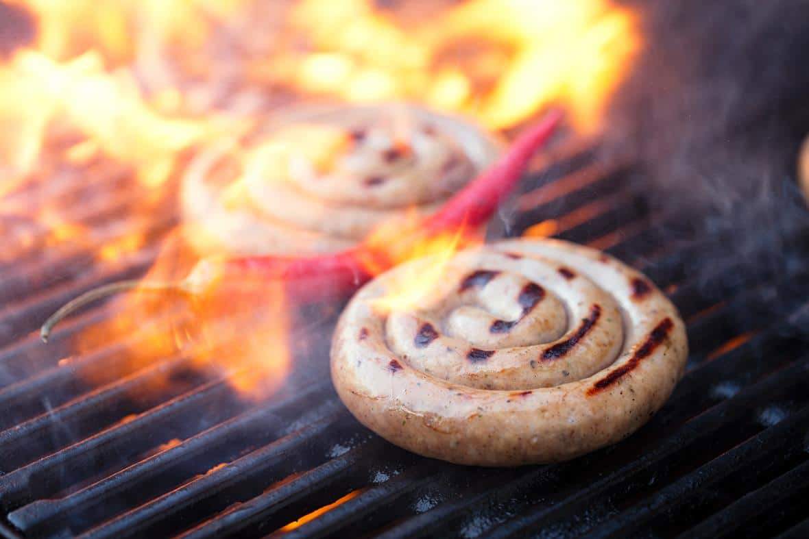 plant based sausage, spiral on bbq grill with flame