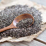 A wooden spoon in a pile of chia seeds