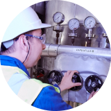 Factory worker looking at production of oils