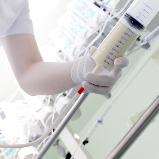 Pharmaceutical Oil being dripped into the test tube in a laboratory