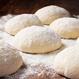 Loaves of unbaked organic flour bread dough