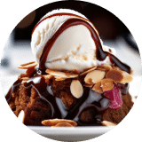 A close-up of a piece of chocolate cake on a plate covered in almond slivers, chocolate sauce and a scoop of vanilla ice cream.