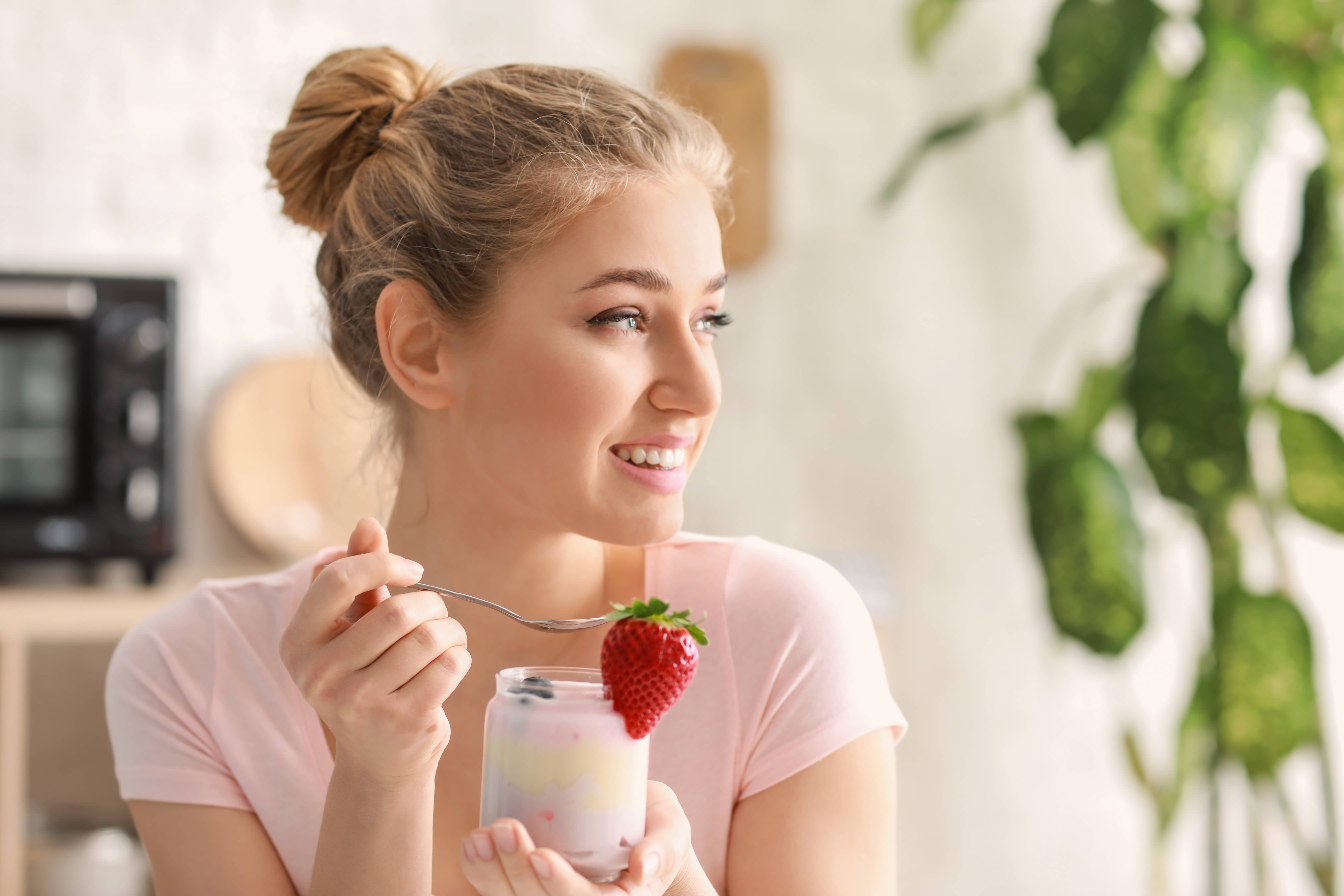 A lady drinking a fruit smoothie