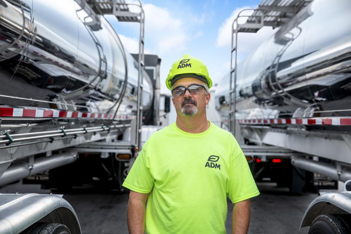 ADM Truck driver standing in front of tanker trucks in Dectaur DecaturRetouchV4 8596 2020 10 v1 lores